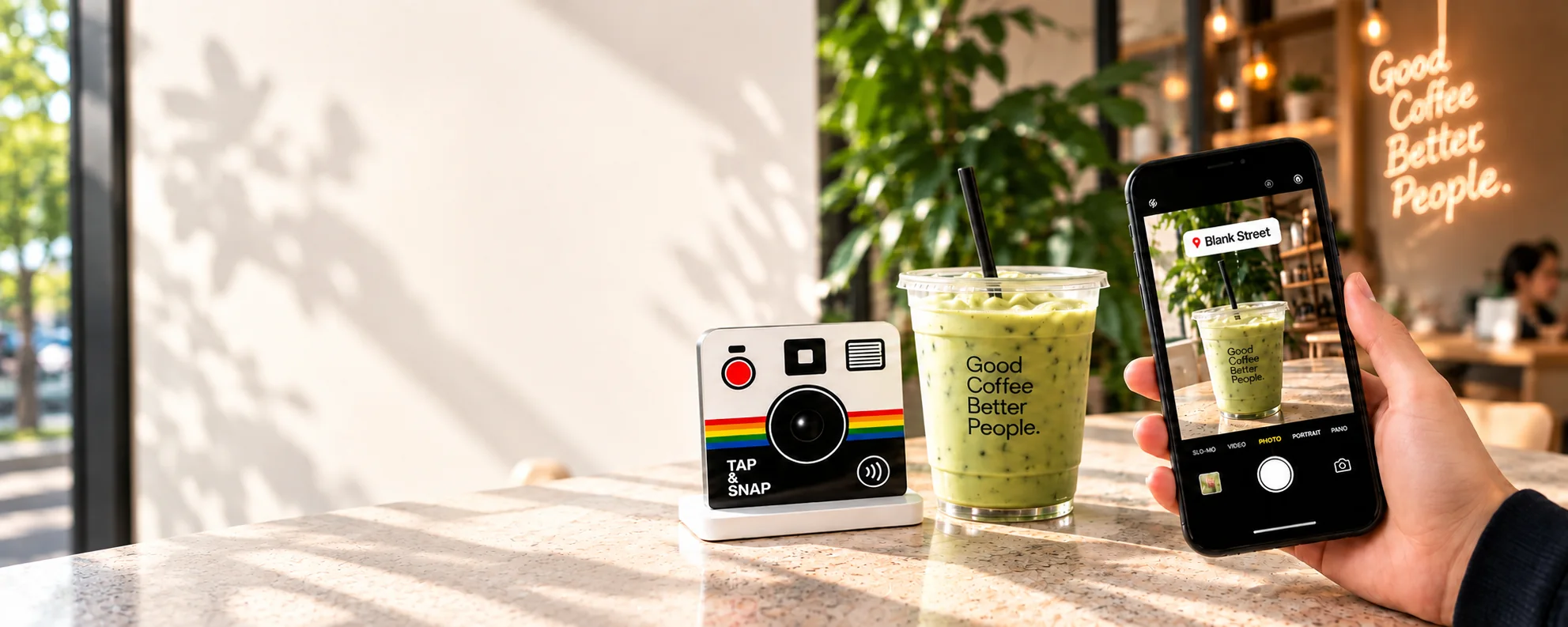 Tap & Snap, an iced matcha, and a customer phone showing a Blank Street branded camera